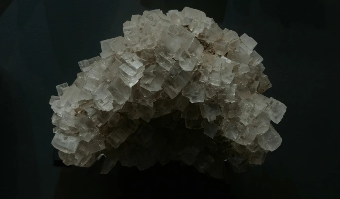 A cluster of salt crystals against a black background.